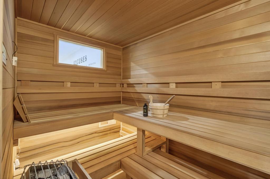 Sauna with a window to see the TV in the exercise room