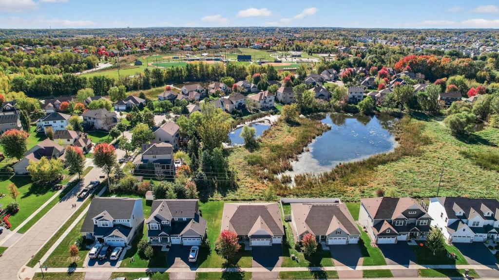 Fall aerial of the pond with Gleason Fields and Athletic Complex in the background. The home is the third from the left.