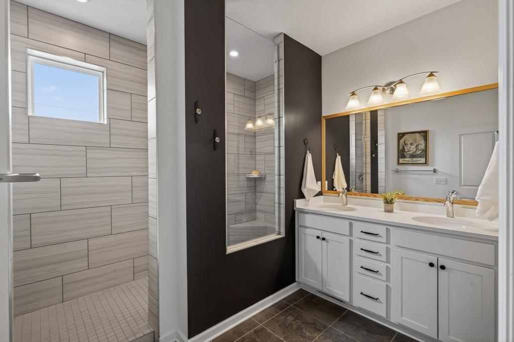 Primary bath with walk-in shower and dual sinks.
