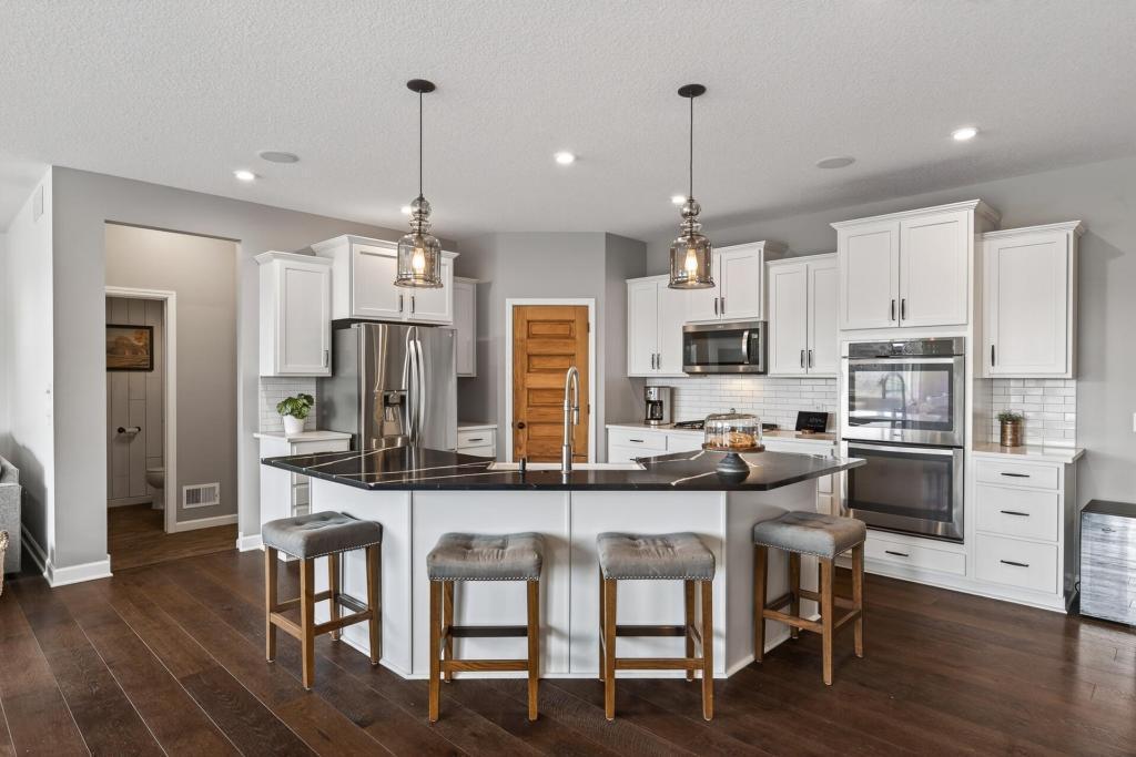 Entertainer's kitchen with vintage pantry door, dual ovens, large center island