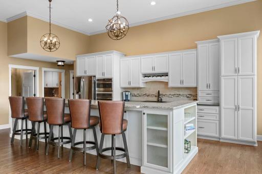 Gorgeous kitchen remodeled featuring an oversized breakfast bar perfect for entertaining or casual meals at home. Custom cabinets, great storage, shelving, tiled backsplash. Check out the double sided island cabinets! No detailed missed.