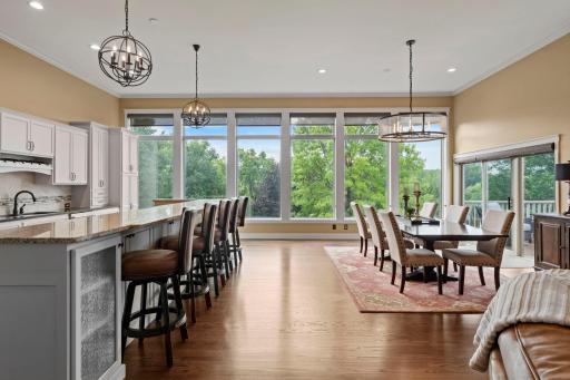 12 foot ceilings and a dramatic wall of windows that fills the home with nature light and captures serene lake views.