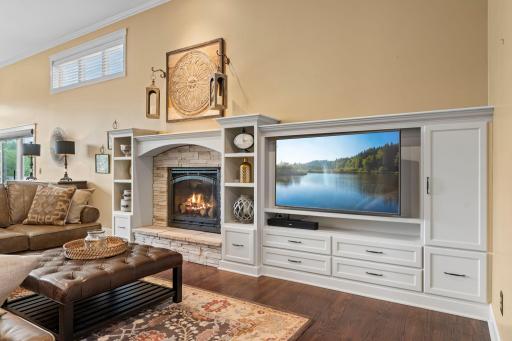Custom built-ins and cozy gas fireplace highlight be beautiful, modern stone! Modern white cabinetry, drawers and custom design.