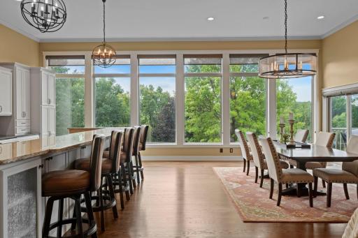 Gorgeous hardwood flooring spans the main-level living, dining, and kitchen areas, while expansive windows showcase breathtaking lake and treed views you'll absolutely love. This setup is hard to find!