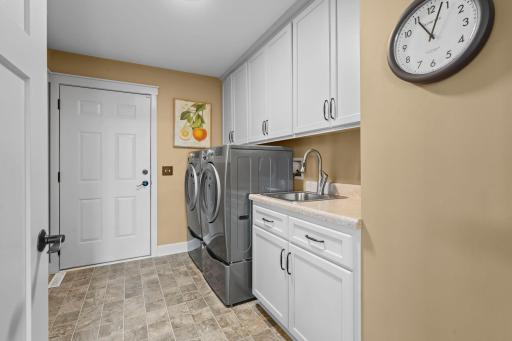All living facilities on the main level including this convenient laundry space with a ton of built-in storage.