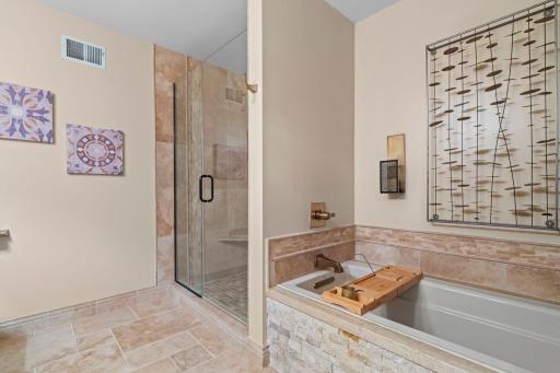 Luxury Primary bathroom with gorgeous tile work and stone. Large soaking tub and oversized shower. Heated floors with thermostat.