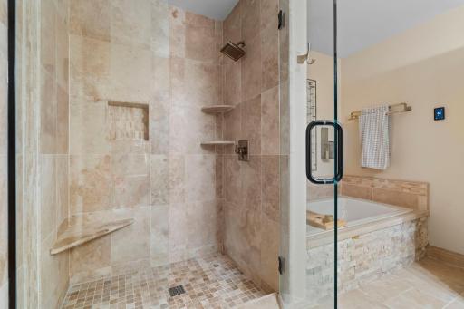 Luxury Primary bathroom with gorgeous tile work and stone. Large soaking tub and oversized shower. Heated floors with thermostat.