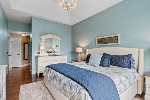 Beautiful white woodwork and hardwood floors span throughout this primary bedroom suite.
