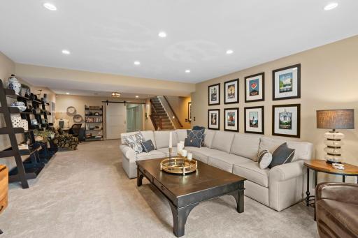 Spacious basement with neutral colors and barn door to fabulous exercise or flex room.
