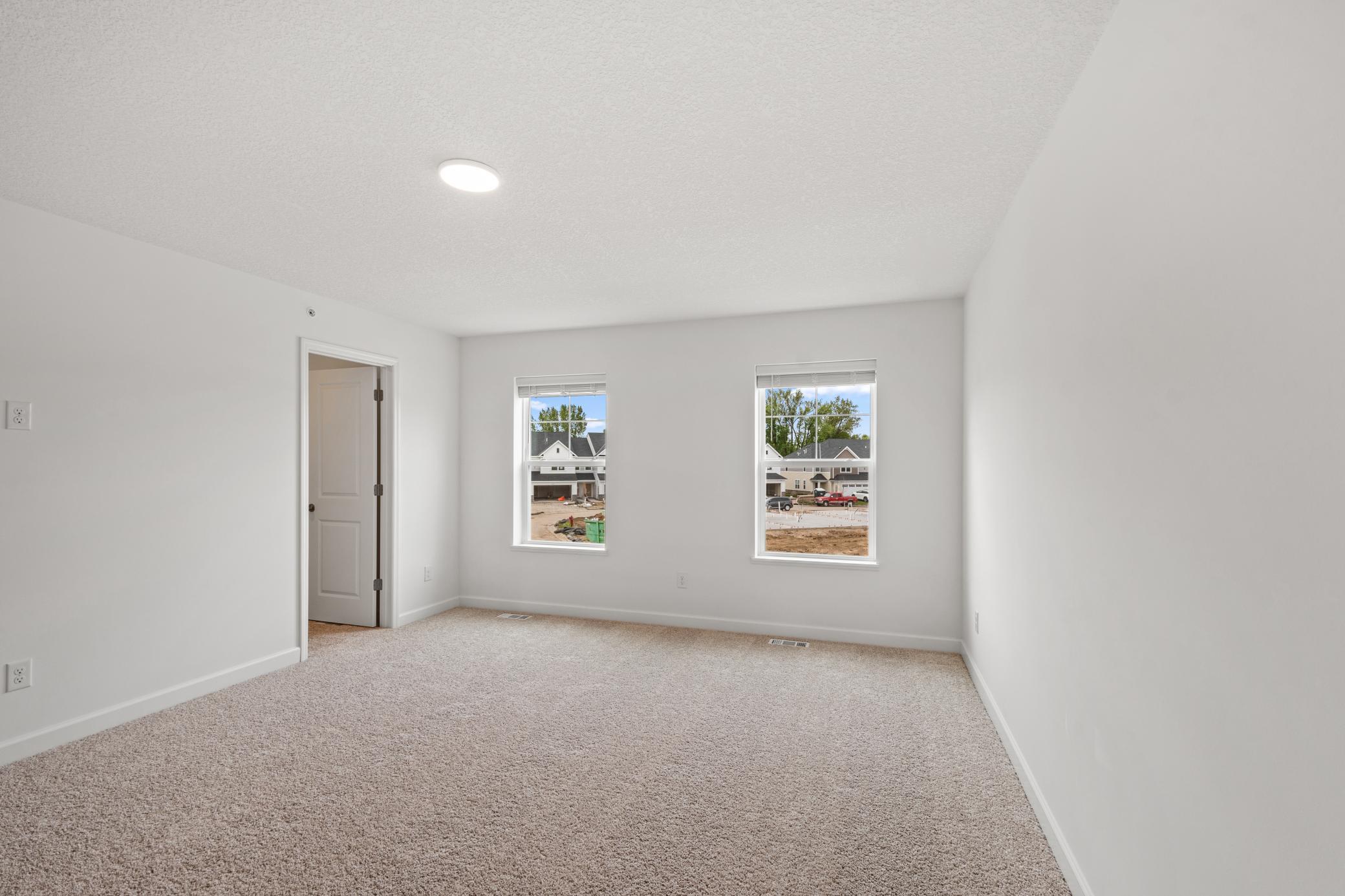(Photo of an inventory home, actual homes finishes will vary) The primary bedroom includes a private bathroom and large walk-in closet.