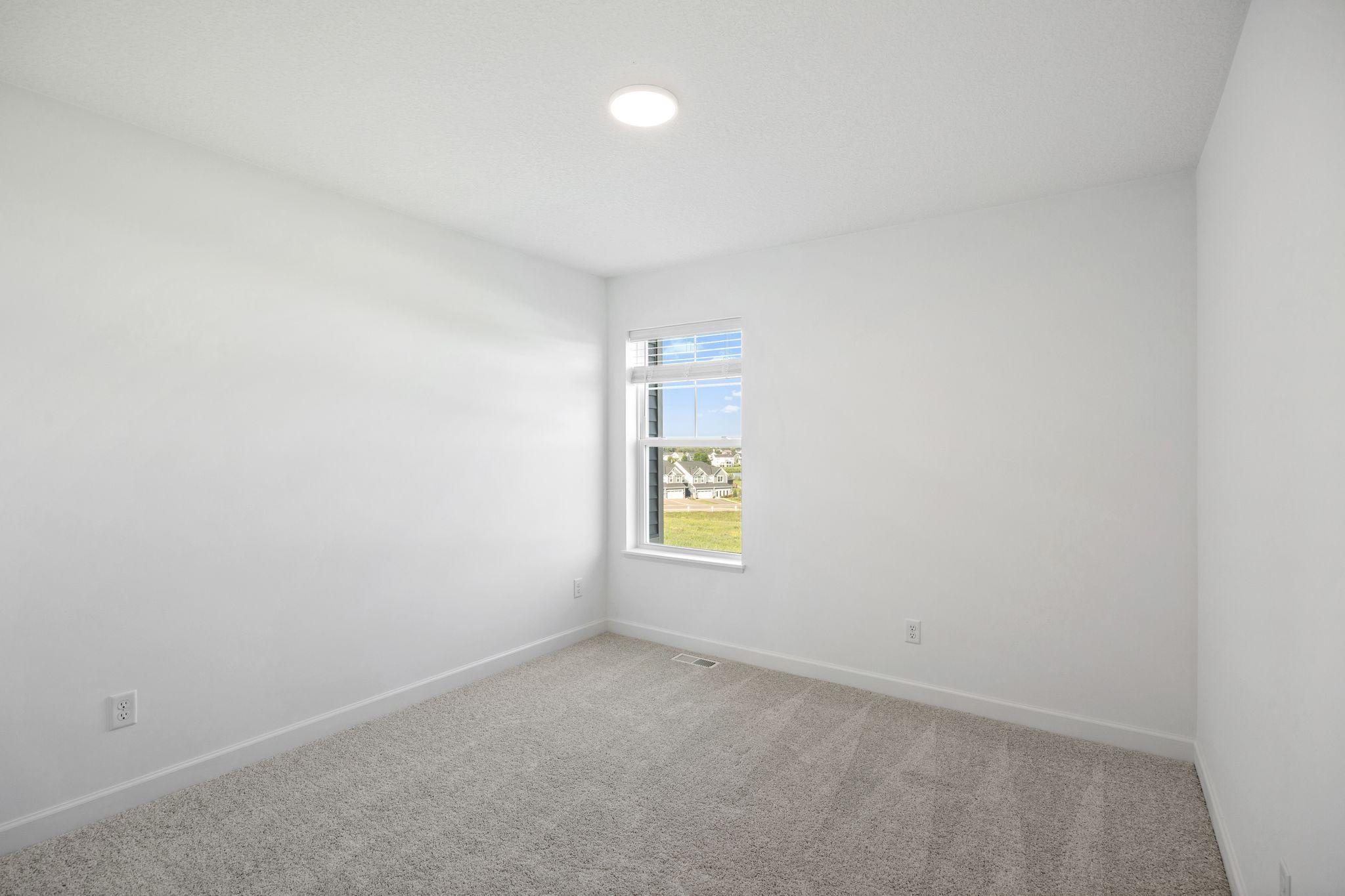 (Photo of a decorated model, actual homes finishes will vary) The other spacious secondary bedroom.