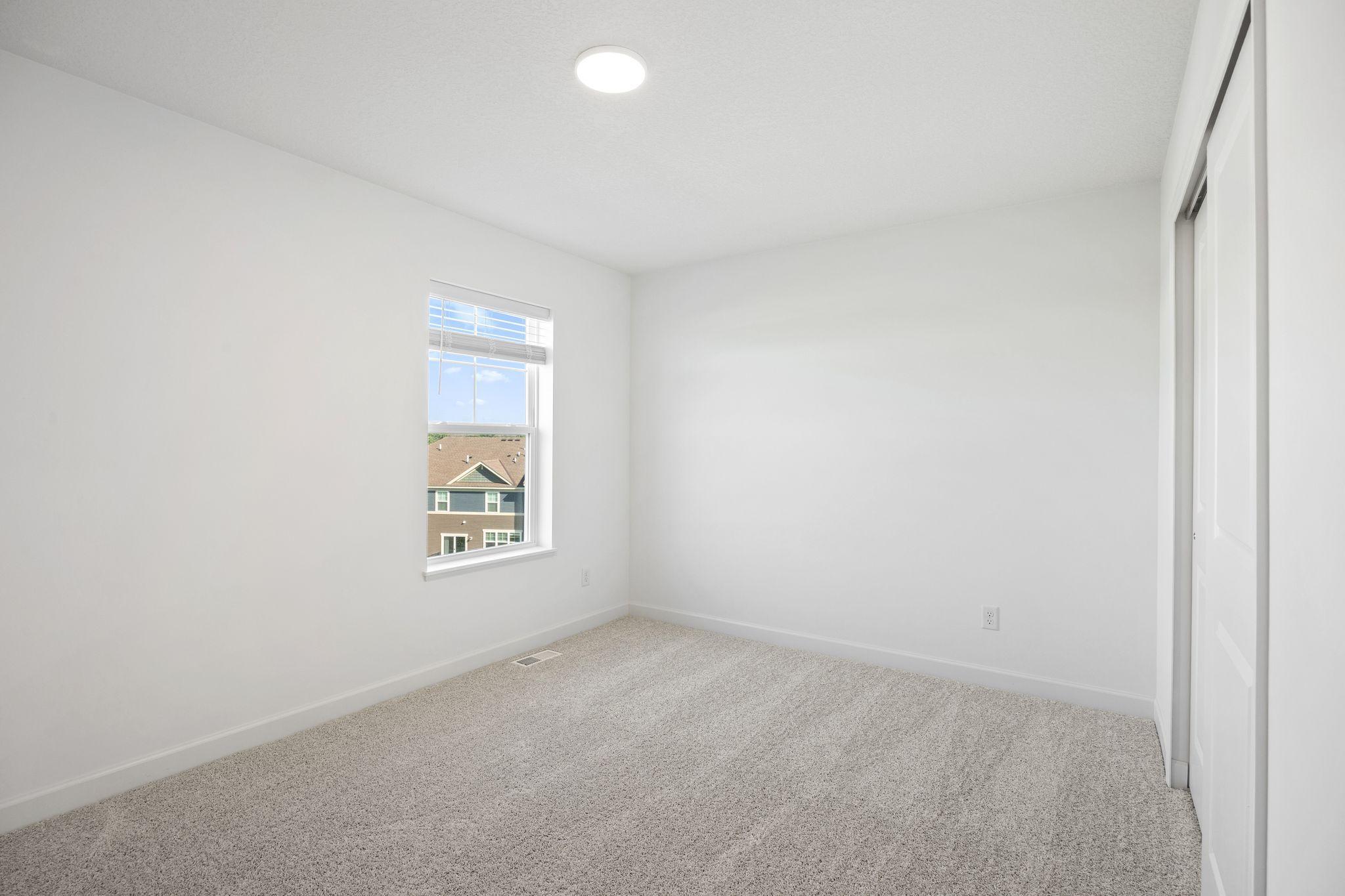 (Photo of a decorated model, actual homes finishes will vary) There are two additional bedrooms on the upper level.