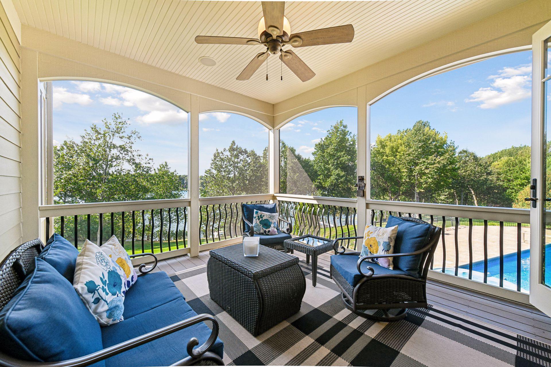 Screened in porch looking over the pool and the lake.