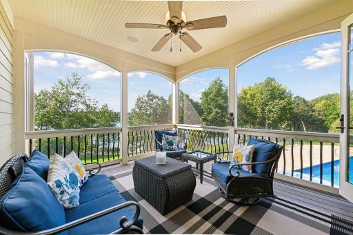 Screened in porch looking over the pool and the lake.