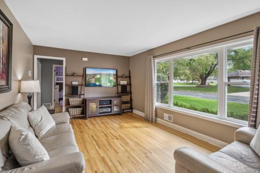 Living room with tons of light and hardwood floors.jpg
