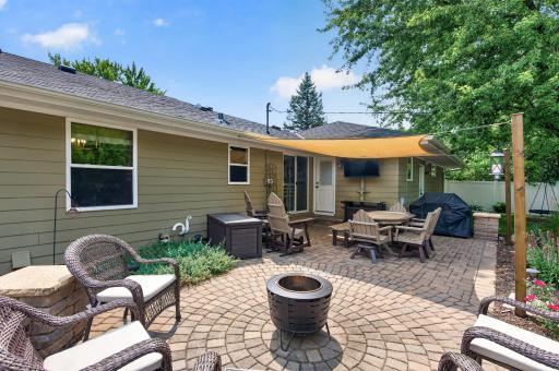 Spacious paver patio with built in TV and speakers for perfect outdoor entertaining.jpg