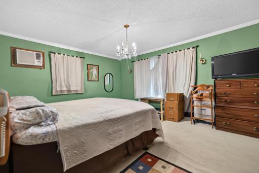 Primary bedroom, lots of windows, virtually altered.