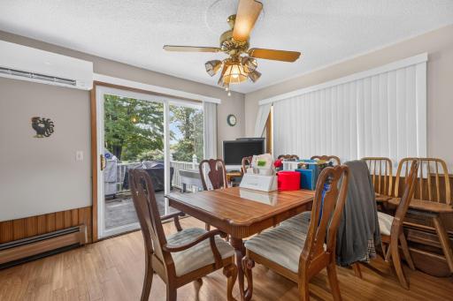 Dinning area with ceiling fan, hard wood floor.