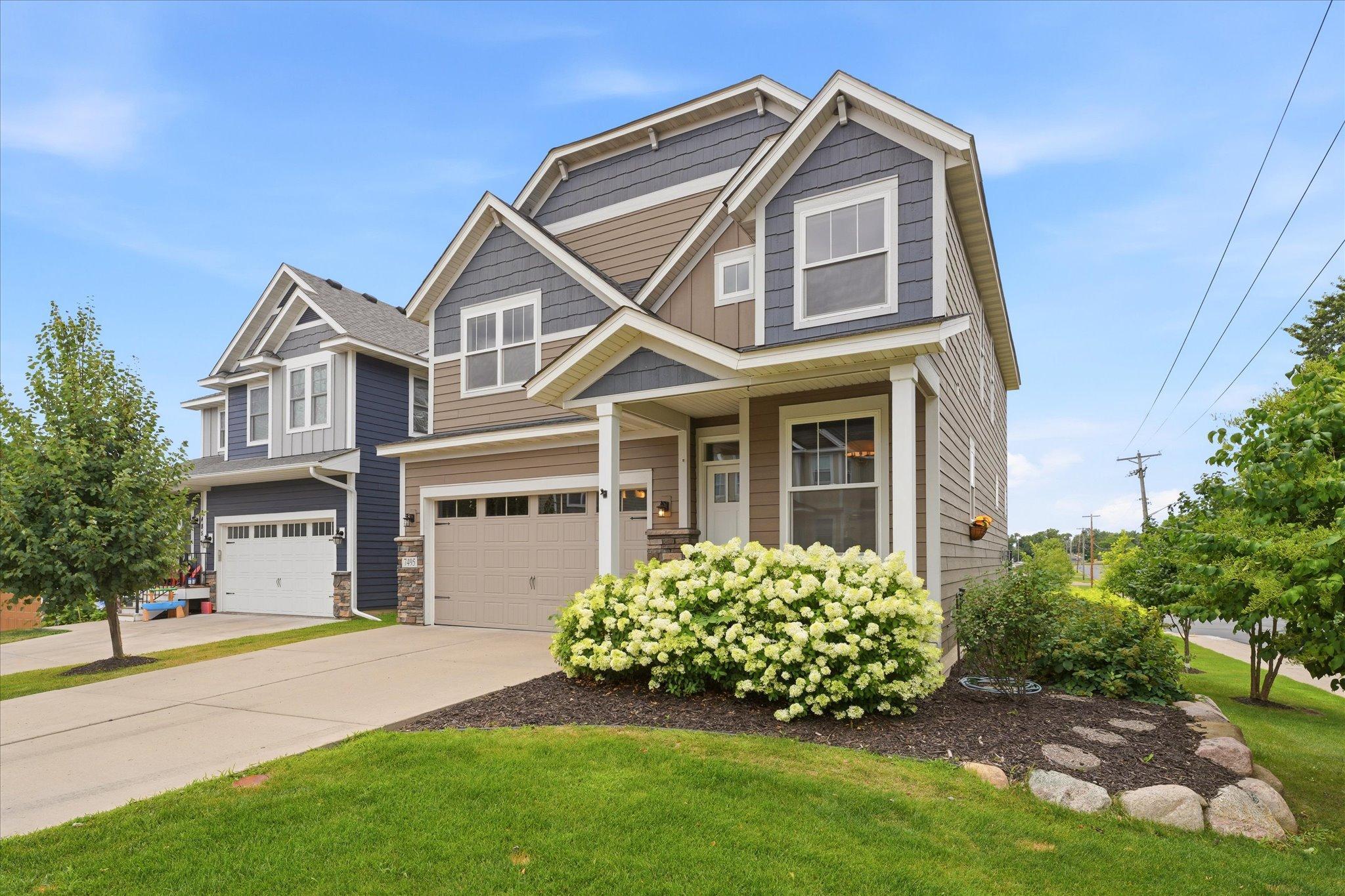 Exceptional curb appeal with professionally maintained landscaping, lush green lawn, and timeless exterior finishes creates a warm and welcoming first impression.