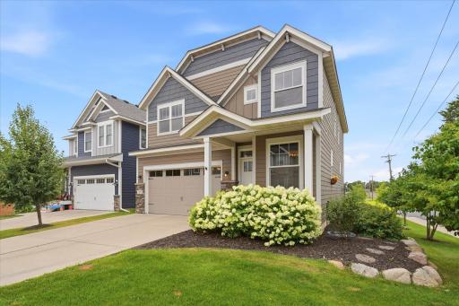 Exceptional curb appeal with professionally maintained landscaping, lush green lawn, and timeless exterior finishes creates a warm and welcoming first impression.