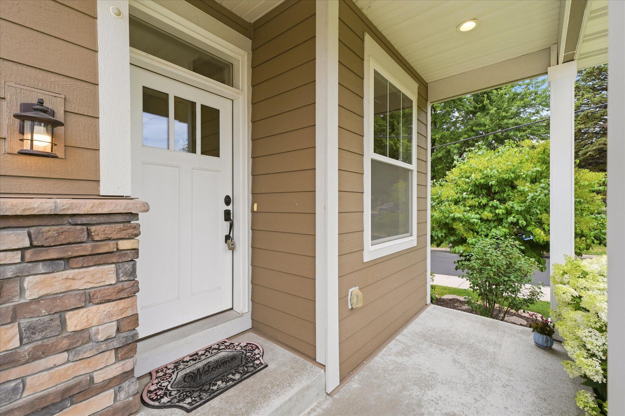 Welcoming covered front porch provides the perfect place to relax with your morning coffee while enjoying the beautifully landscaped front yard.