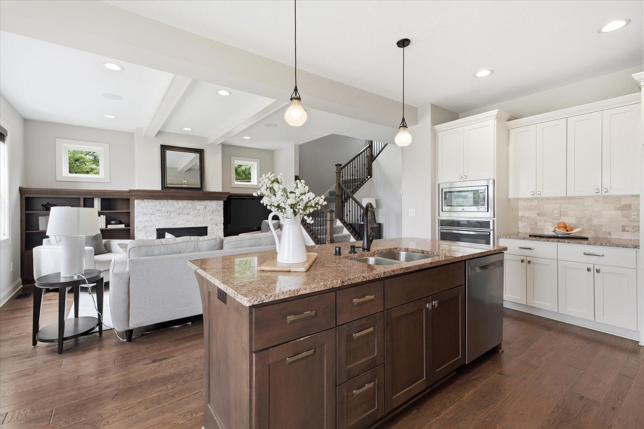 Expansive center island with granite countertops, undermount sink, abundant storage, and seating makes this kitchen the true heart of the home.