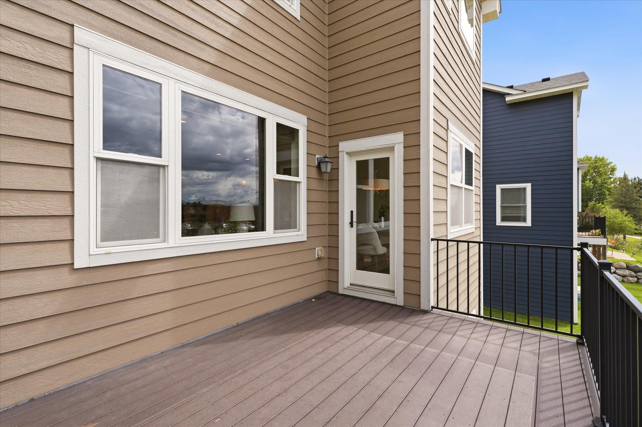 Maintenance-free deck provides the perfect space for grilling, dining, or relaxing while overlooking the beautifully maintained neighborhood.