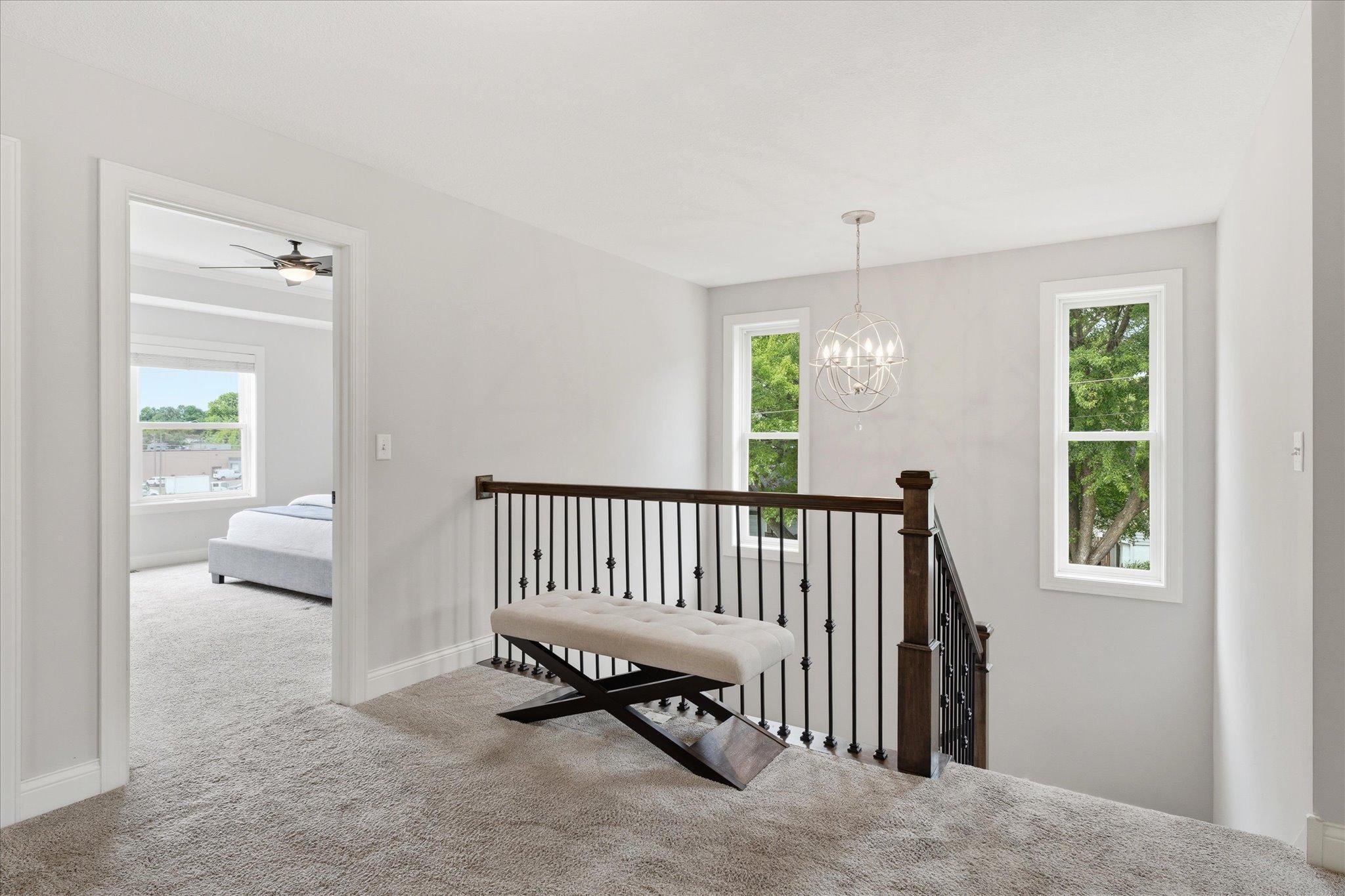 Bright upper-level landing offers easy access to all four bedrooms, the laundry room, and full bath.
