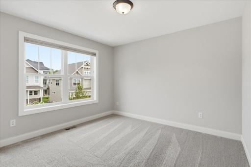 Bedroom #4 features a spacious layout, oversized window, and neutral finishes.