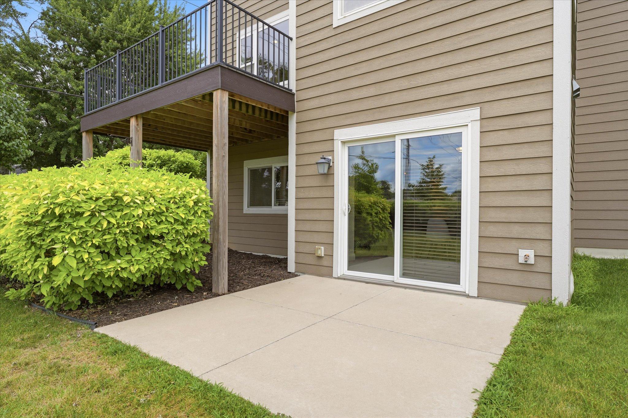 Private concrete patio extends your outdoor living space and is conveniently accessed from the walkout lower level, making it ideal for relaxing, grilling, or entertaining while enjoying the landscaped surroundings.