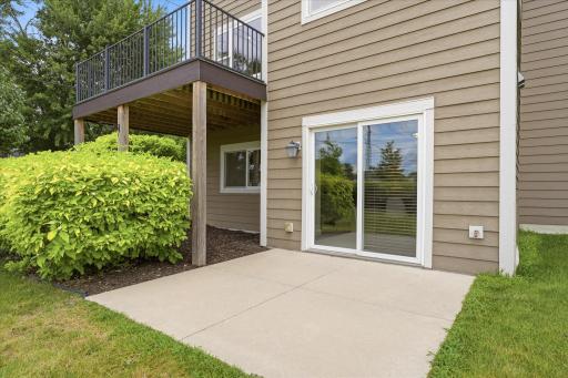 Private concrete patio extends your outdoor living space and is conveniently accessed from the walkout lower level, making it ideal for relaxing, grilling, or entertaining while enjoying the landscaped surroundings.