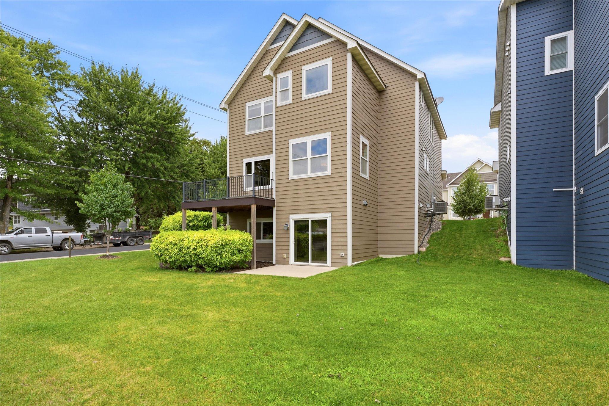 Walkout lower level provides seamless access to the backyard patio while the elevated deck above creates the perfect setting for outdoor dining and entertaining.
