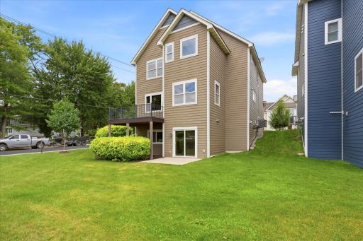 Walkout lower level provides seamless access to the backyard patio while the elevated deck above creates the perfect setting for outdoor dining and entertaining.