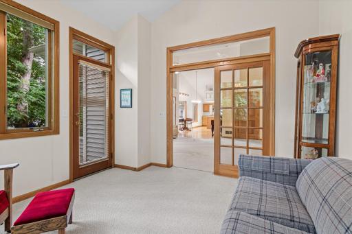 Sunroom looking into the open and large living room with vaulted ceilings and natural light