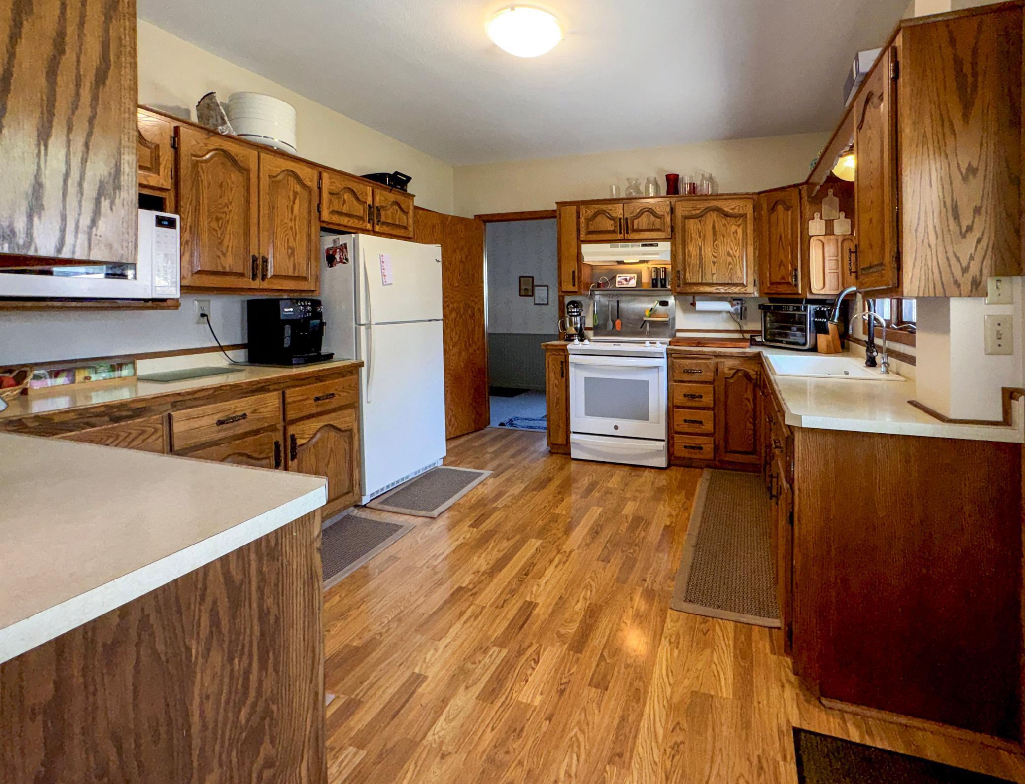 Spacious kitchen featuring beautiful custom oak cabinetry and abundant workspace.