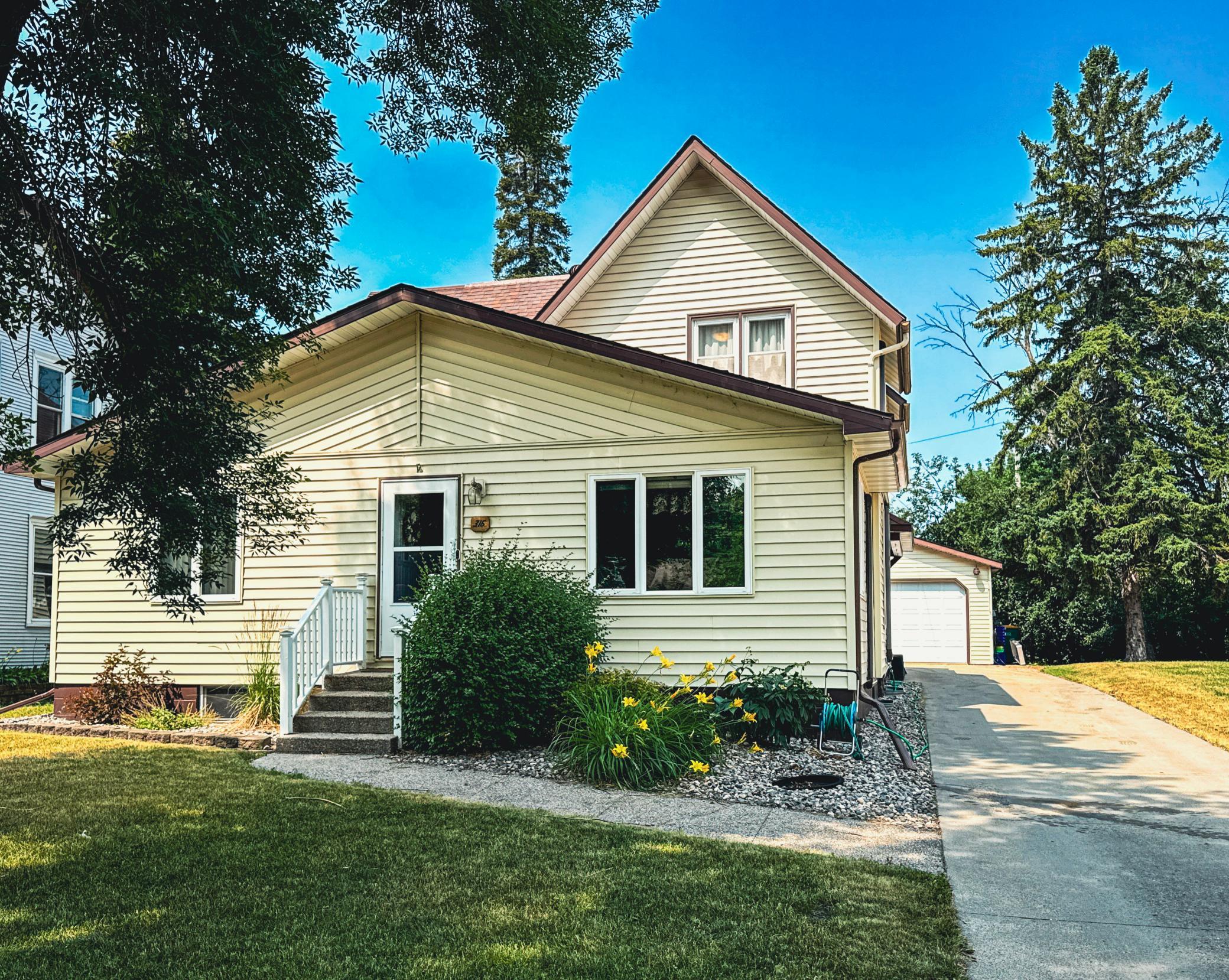 Spacious 4,300+ sq. ft. home in Crookston, MN with timeless curb appeal and a long concrete driveway.