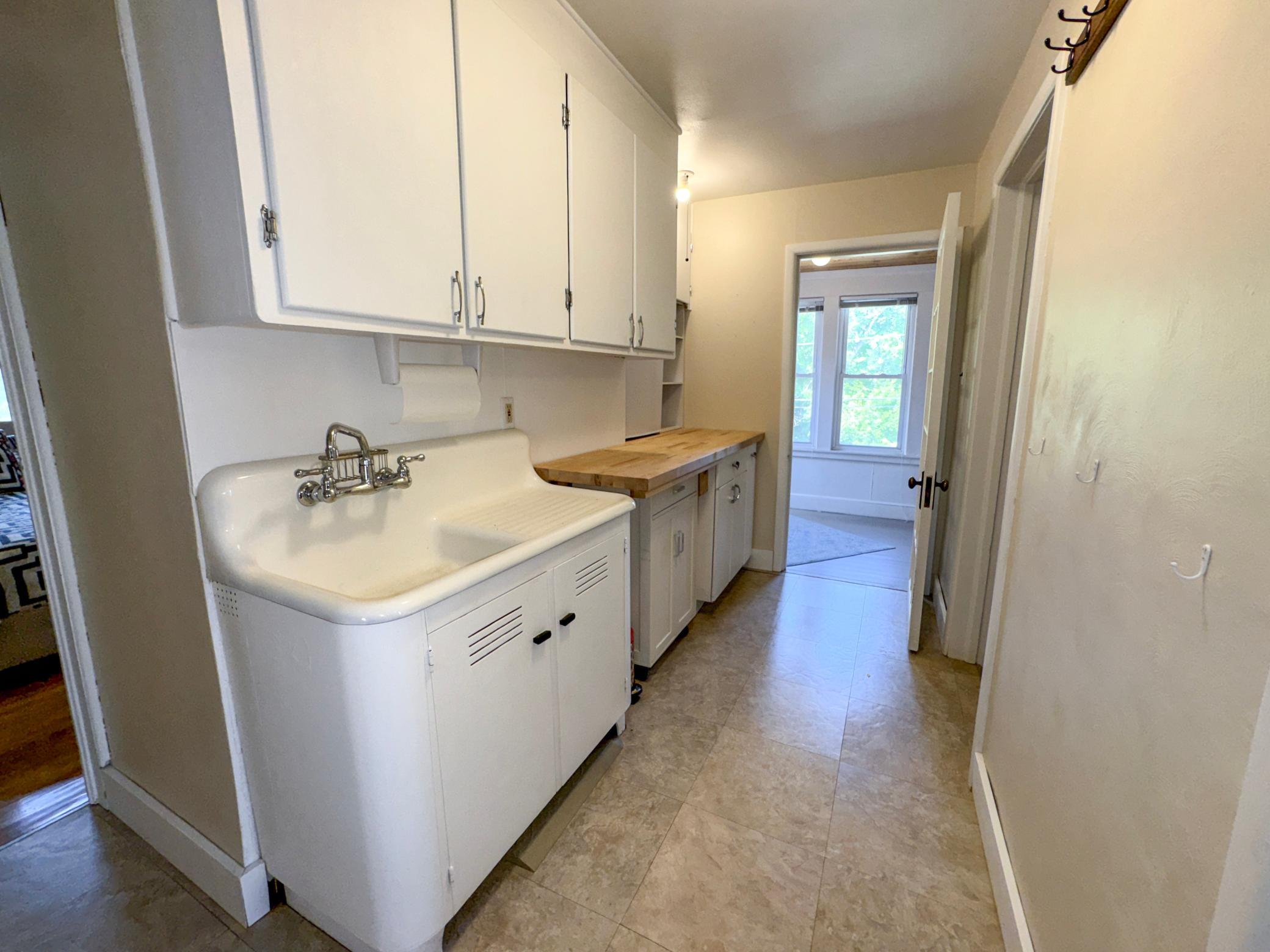 Charming upstairs kitchenette featuring a beautiful cast iron sink.