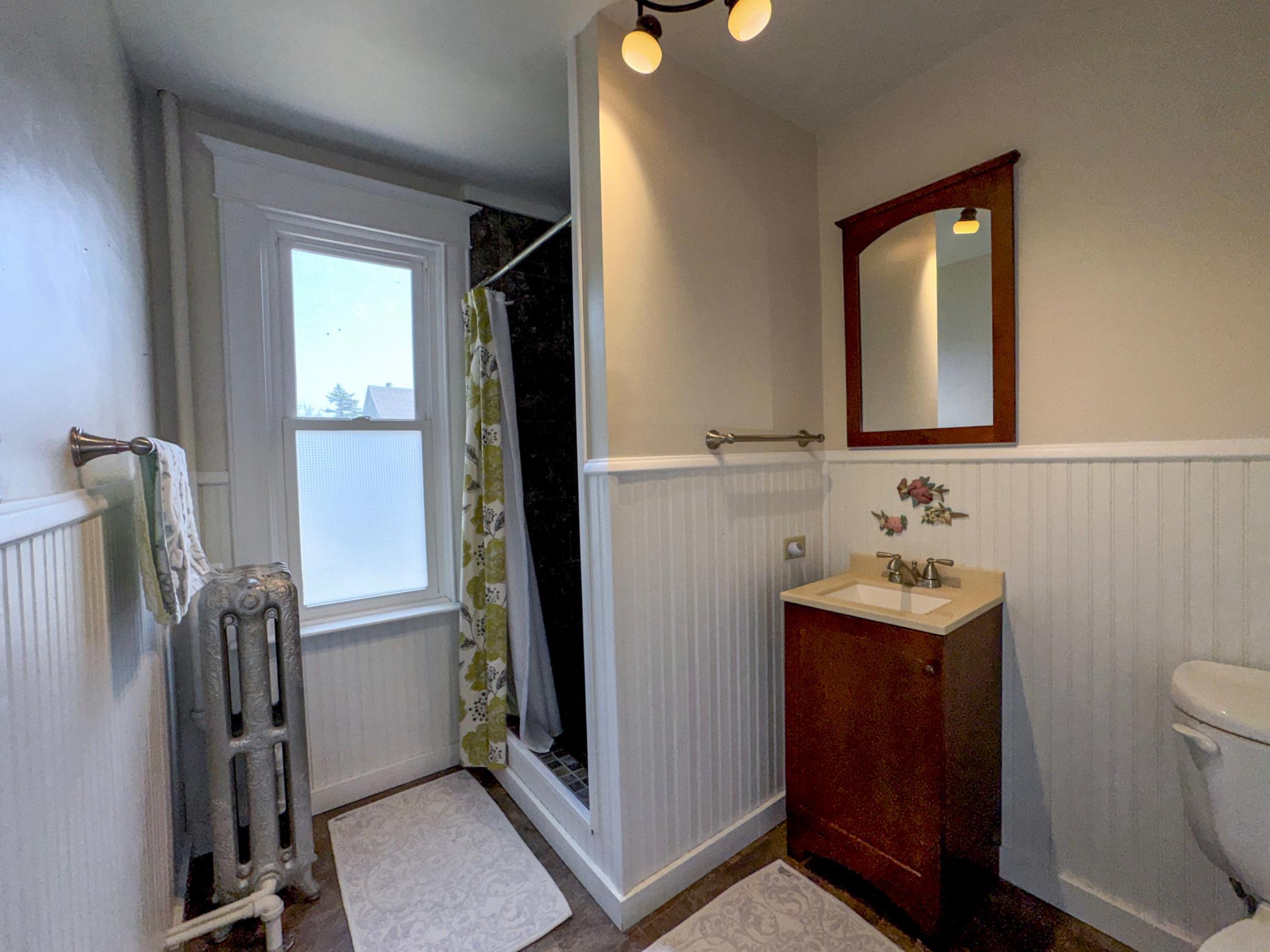 Upper level 3/4 Bathroom with a tiled walk in shower