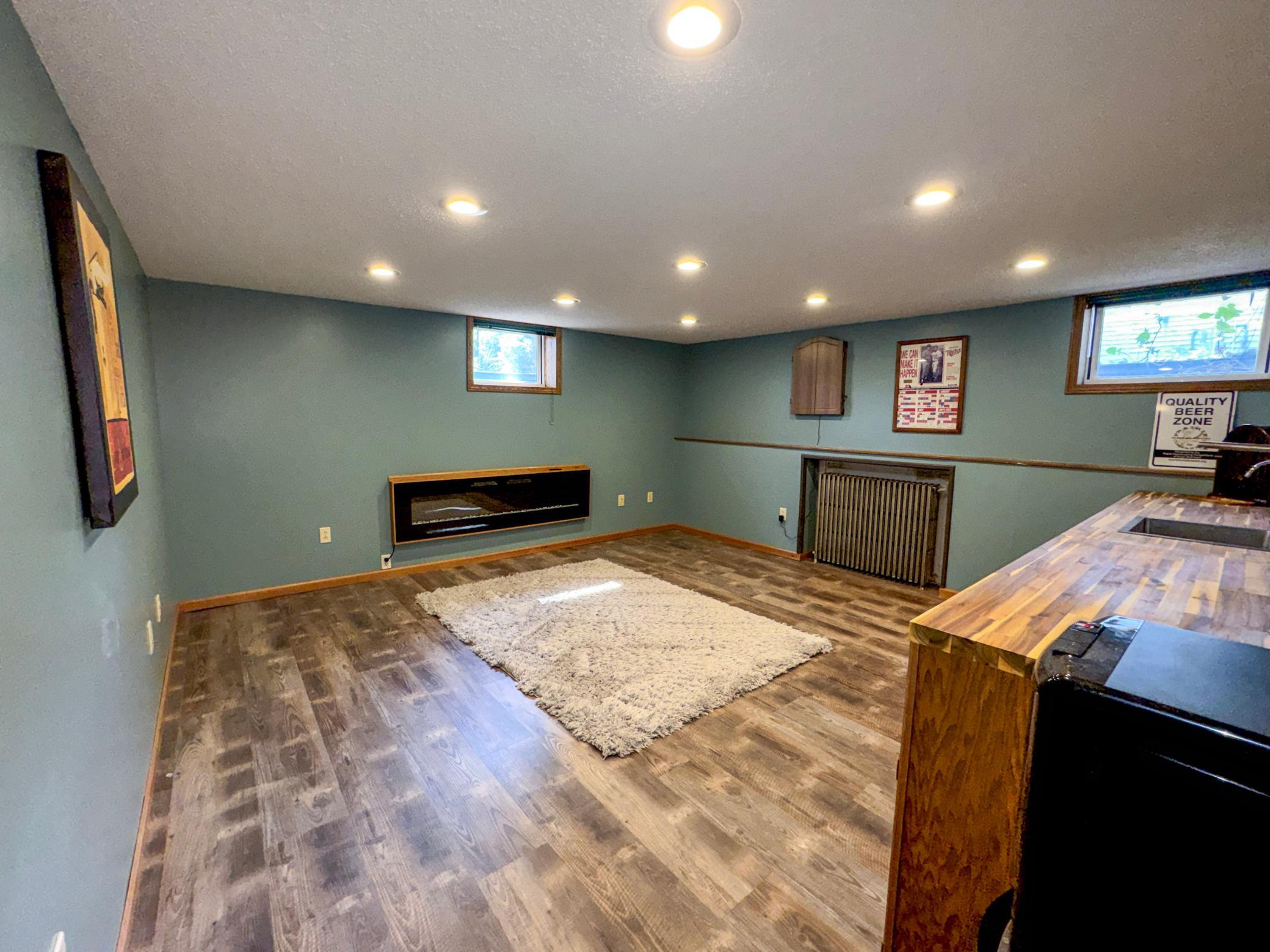 Lower Level Kitchenette or Bar with a fireplace and a wetbar / sink