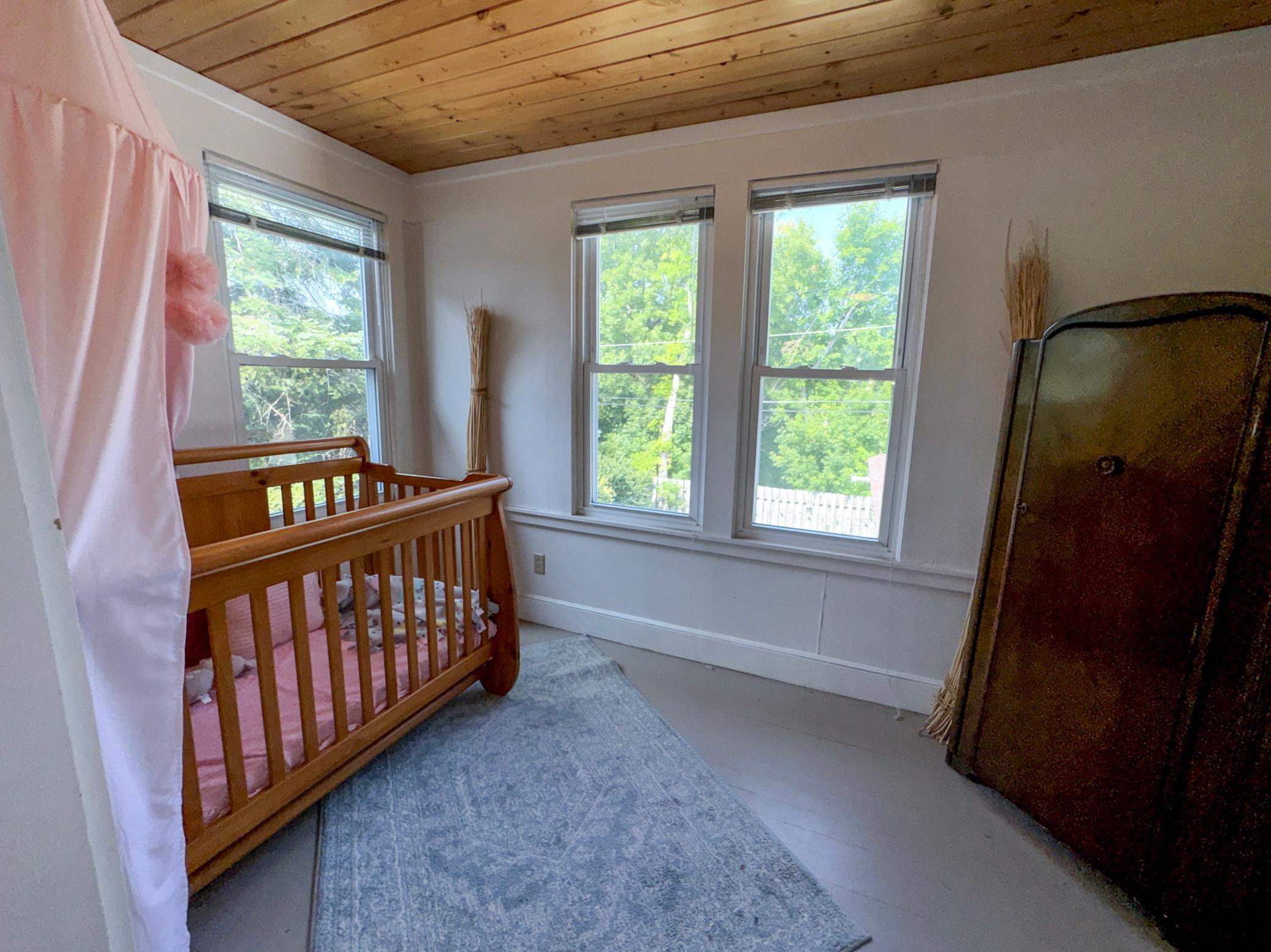 Upper Level Bedroom #3 with lots of natural light flowing through and a beautiful tongue and groove ceiling