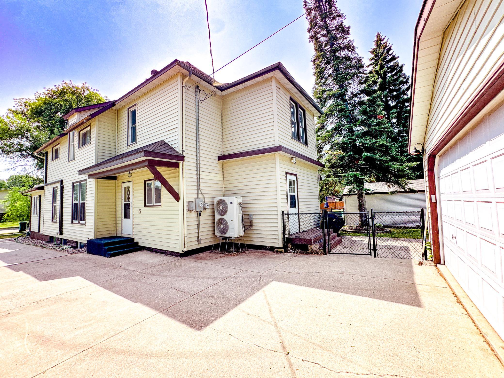 Extra-long concrete driveway offers abundant off-street parking for guests and multiple vehicles.
