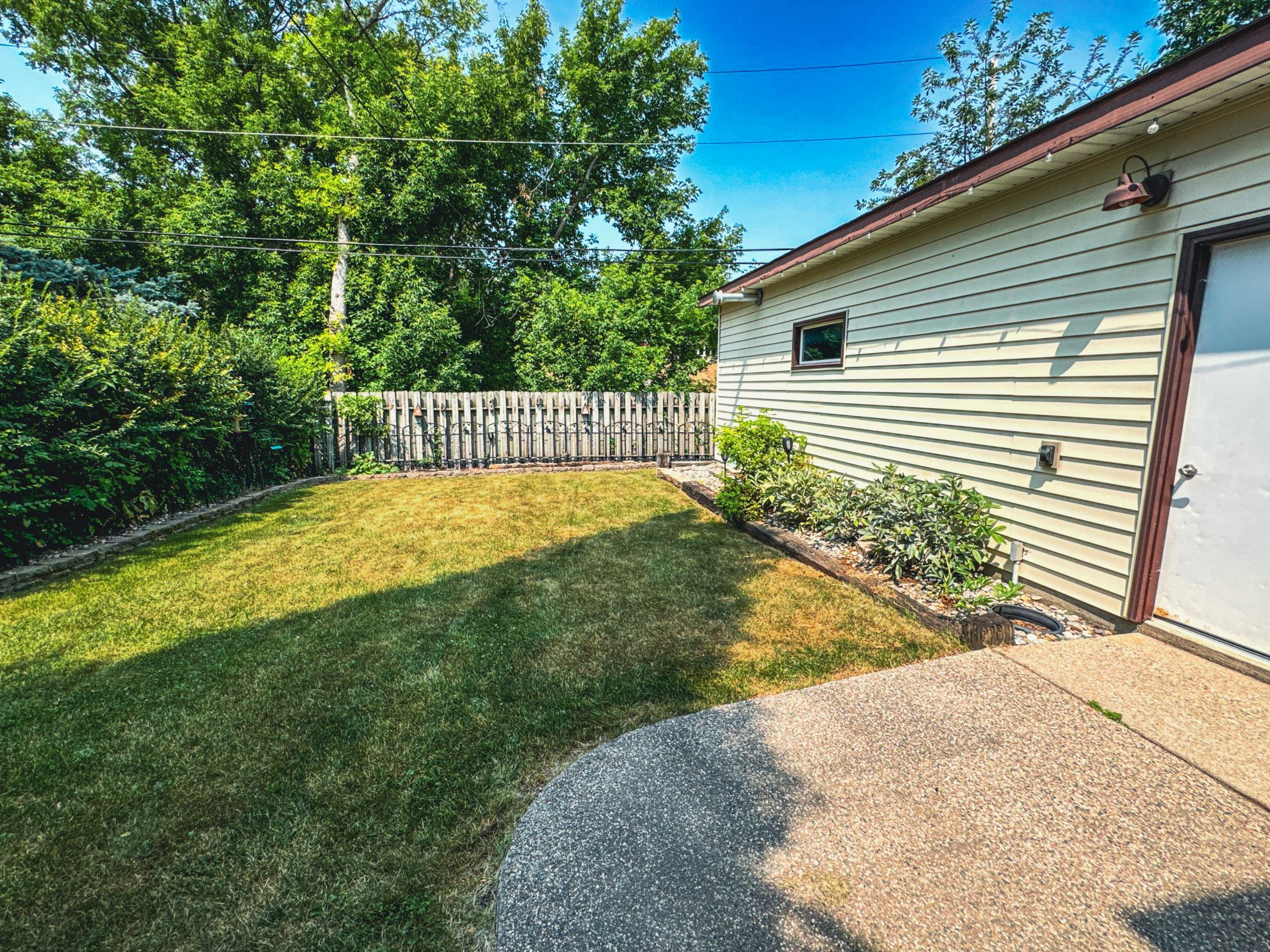 Enjoy quiet evenings on the backyard patio overlooking the fenced yard.