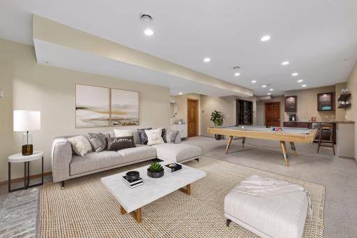 An additional family room awaits in the lower level, along with a wood-burning fireplace and the added comfort of in-floor heat - *VIRTUALLY STAGED*