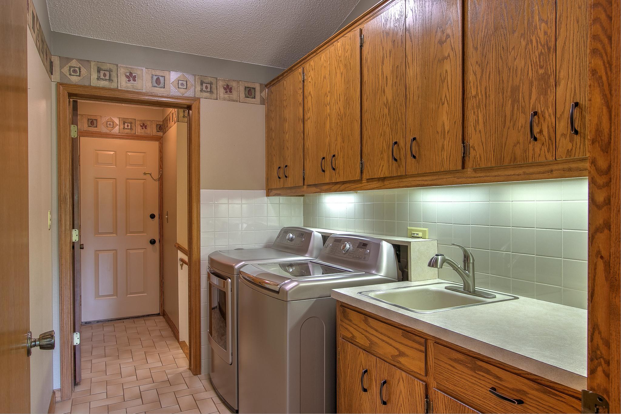 Main floor laundry just off rear entry w/ stairway to LL