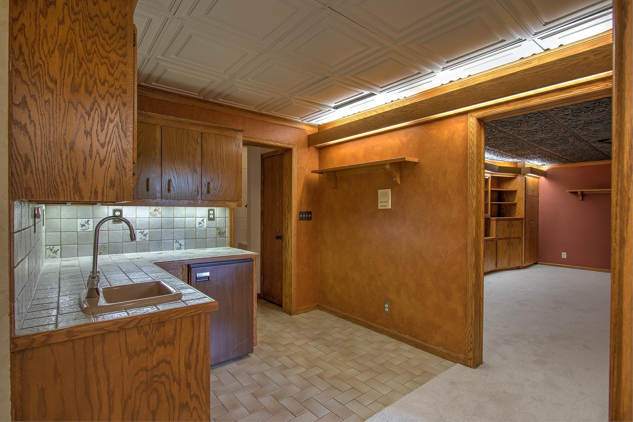 Stairway connects laundry & LL wet bar