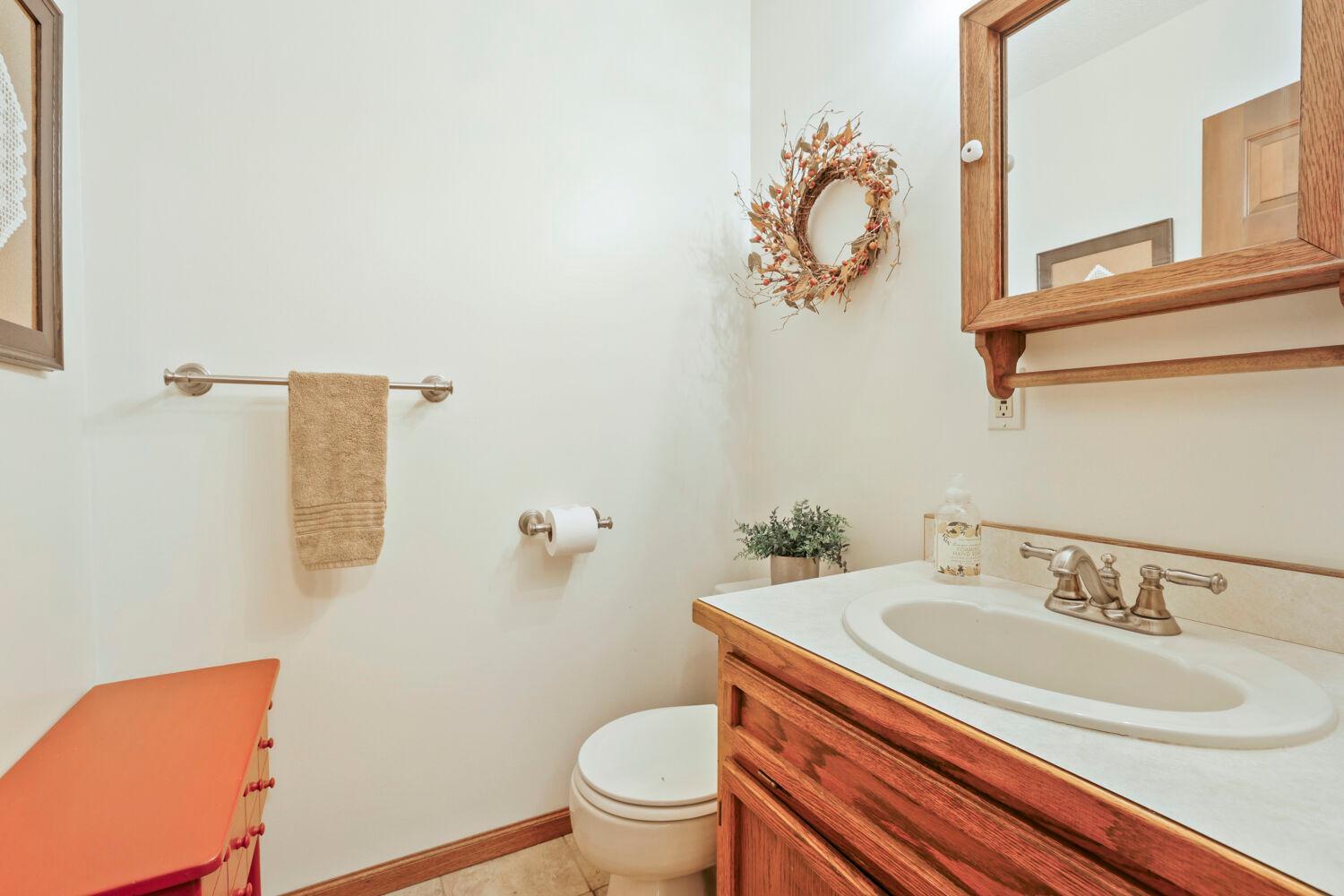 The main level 1/2 bath at the side entry from the screened porch.
