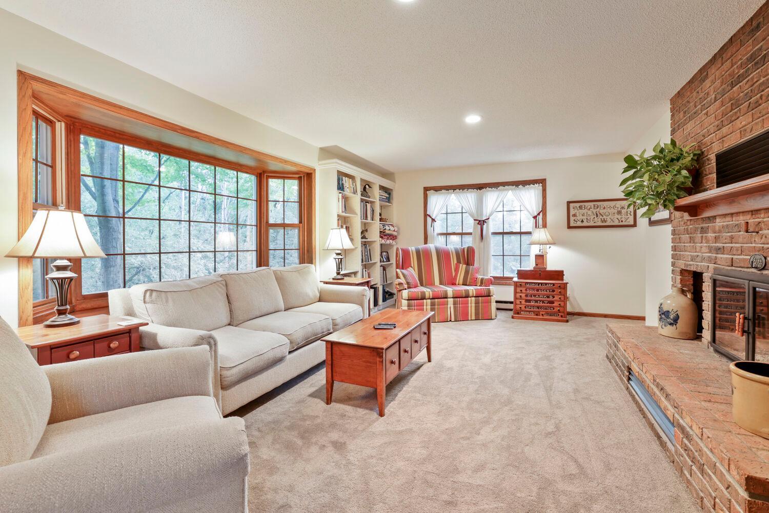 The bay window area is just one of many windows in this large living area.