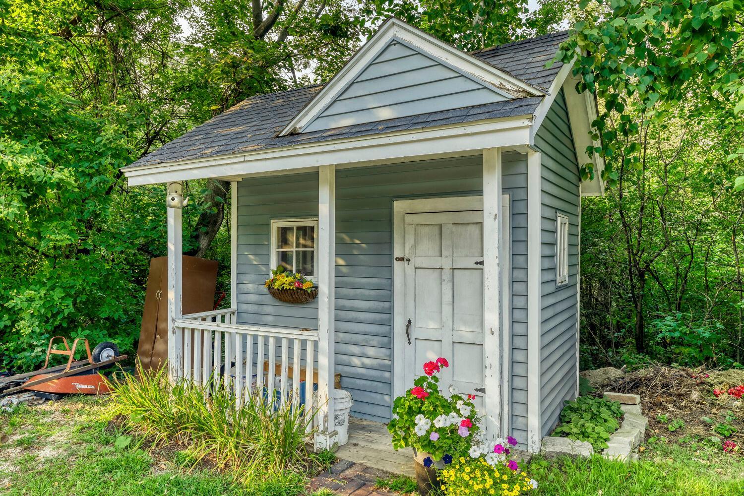 This cute little garden shed is a great little space for garden tools, but how about a childs playhouse?