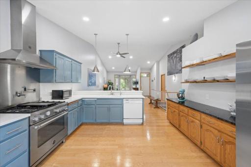 The expansive buffet is topped with granite and has open shelving above for display and storage.