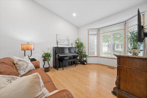 Natural light spills into the living room from the large bay window.